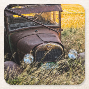 Abandoned old car in tall grass square paper coaster