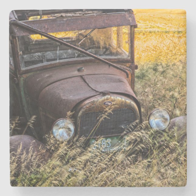 Abandoned old car in tall grass stone coaster (Front)