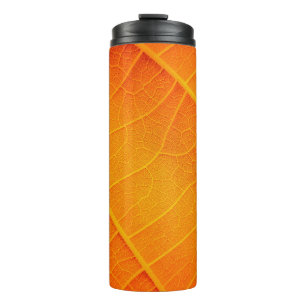 Abstract closeup of an orange and yellow leaf text thermal tumbler
