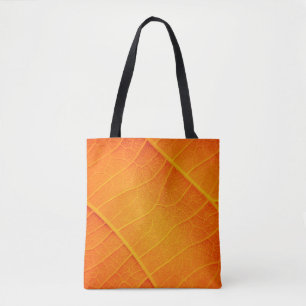 Abstract closeup of an orange and yellow leaf text tote bag