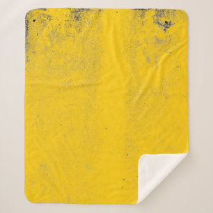 Abstract colourful yellow cement wall texture and sherpa blanket