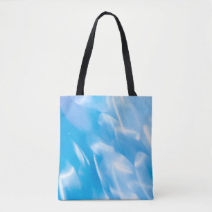 Abstract glitter lights on blue background. Round Tote Bag