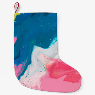 Abstract pink and turquoise paint background with  small christmas stocking