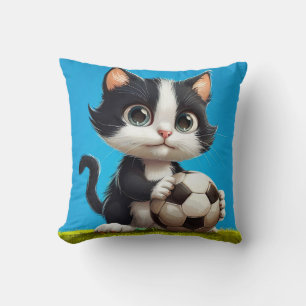 Adorable Black And White Kitten Holding A Ball Cushion