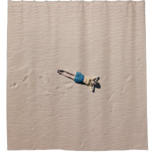 Aerial photograph of man lying on sand shower curtain
