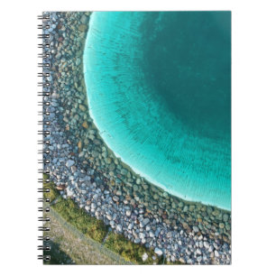 Aerial photography of body of water surrounded wit notebook