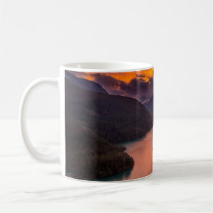 AERIAL PHOTOGRAPHY OF LAKE VIEWING MOUNTAIN UNDER COFFEE MUG