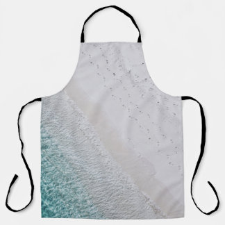 AERIAL PHOTOGRAPHY OF WHITE SAND SEASHORE AND GREE APRON