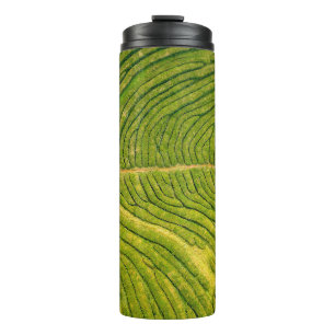 Aerial view of green open field thermal tumbler