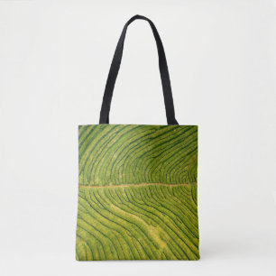 Aerial view of green open field tote bag