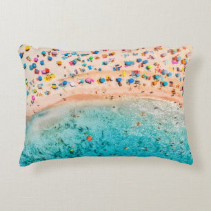Aerial view of sandy beach with colorful umbrellas decorative cushion