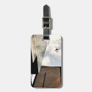 Aeroplanes flying over buildings luggage tag