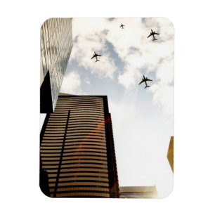 Aeroplanes flying over buildings magnet