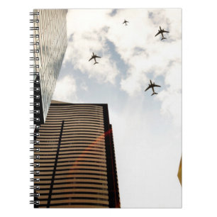 Aeroplanes flying over buildings notebook