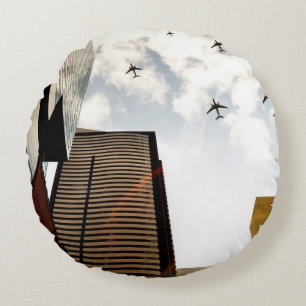 Aeroplanes flying over buildings round cushion