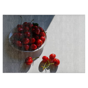 Aesthetic still life with ripe cherries on a white cutting board