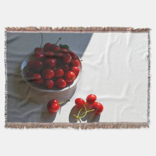 Aesthetic still life with ripe cherries on a white throw blanket