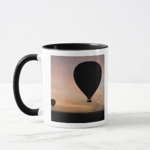 Africa, Kenya, Masai Mara. Two balloons glide Mug