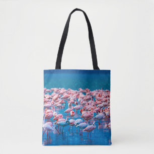African flamingos. Group of flamingos stand in the Tote Bag