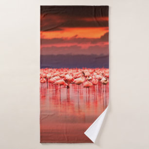 African flamingos in the lake over beautiful sunse bath towel
