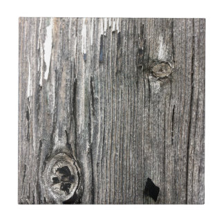 Aged wood fence posting from rustic bush setting tile