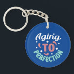 Aging To Perfection -  Key Ring<br><div class="desc">This keychain is perfect for anyone who is proud of their age and wants to show it off! The words “Aging to Perfection” are printed in bold letters on a high-quality metal keychain that will last for years to come. This keychain makes a great gift for anyone who is celebrating...</div>