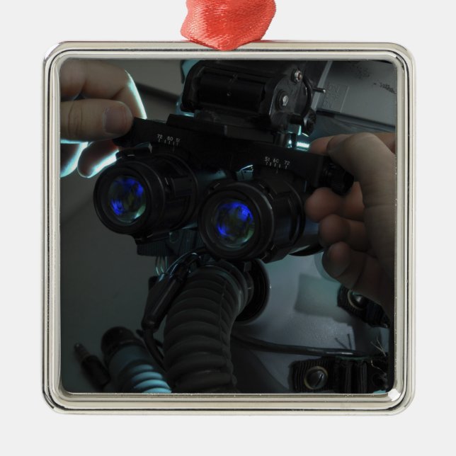 Airman adjusts the eyespan metal tree decoration (Front)