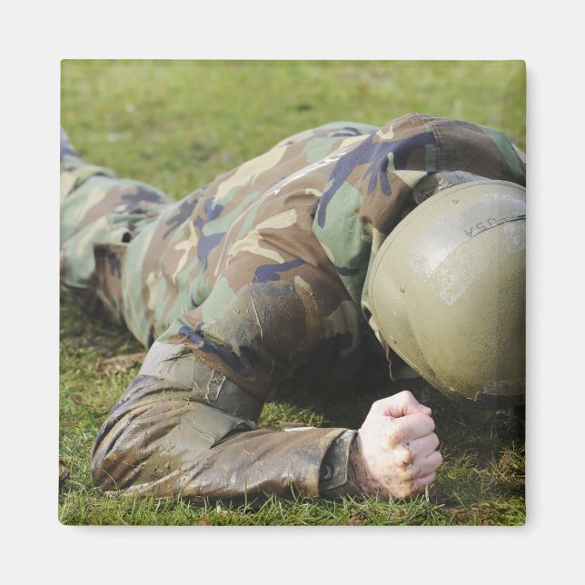 Airman crawls through a wet field magnet (Front)