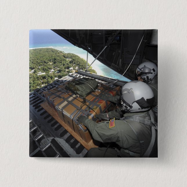 Airmen push out a pallet of donated goods 2 15 cm square badge (Front)