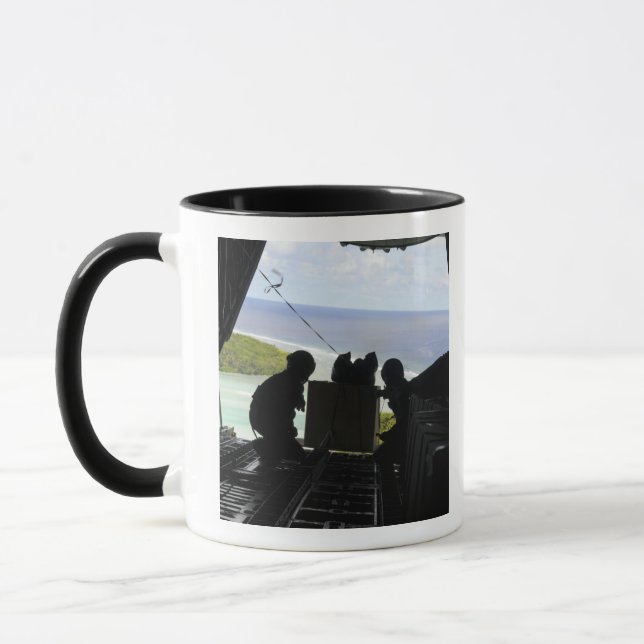 Airmen push out a pallet of donated goods mug (Left)