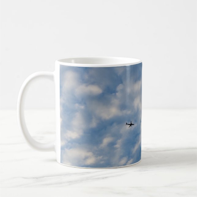 Airplane Crossing a Cloud-Filled Blue Sky Coffee Mug (Left)