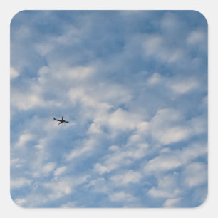 Airplane Crossing a Cloud-Filled Blue Sky Square Sticker