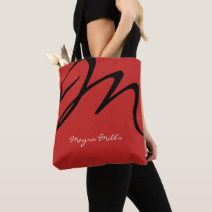 all-over-print red tote bag with black initial