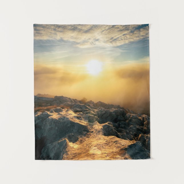 Amazing sunset above clouds and sun lit rocks tapestry (Front)