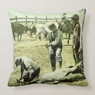 American cowboys branding a calf, c.1900 (photo) cushion