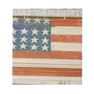 American flag painted onto fireworks stand near notepad