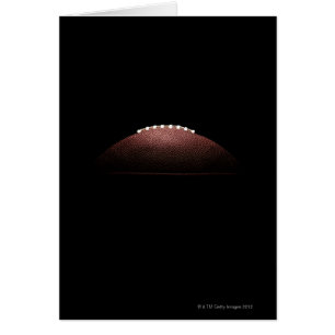 American football ball on black background