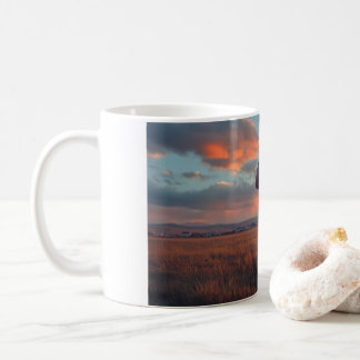 American football flying at dusk over a small town coffee mug