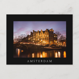 Amsterdam canal houses at dusk black postcard