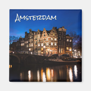 Amsterdam canal houses at night with text magnet