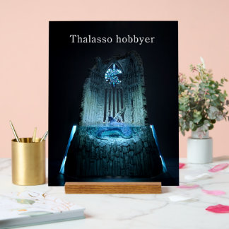 An acrylic sign of "The Prayer Ruins and Guardians