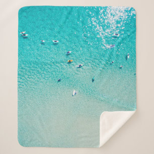 An aerial view of surfers waiting for a wave in th sherpa blanket