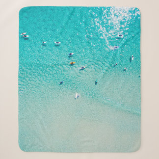 An aerial view of surfers waiting for a wave in th sherpa blanket