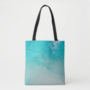 An aerial view of surfers waiting for a wave in th tote bag