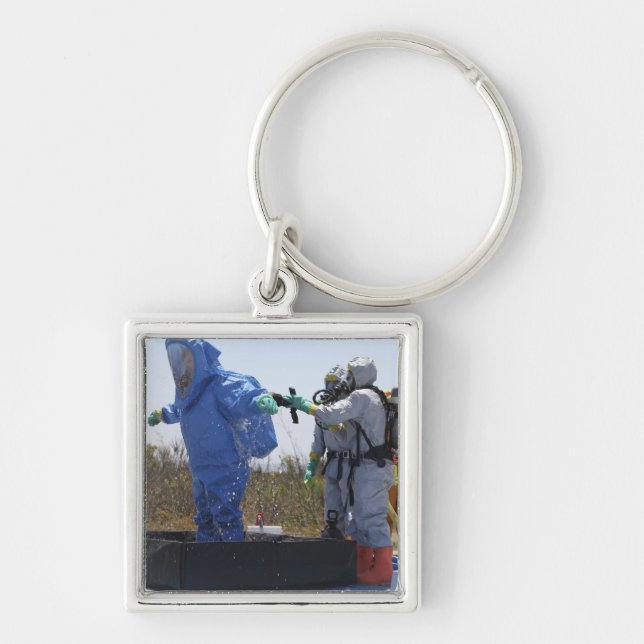 An airman stands in a tub key ring (Front)