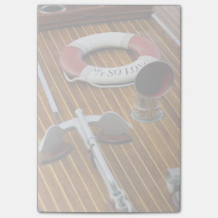 An Anchor And A Life-Buoy On A Wooden Boat Post-it Notes