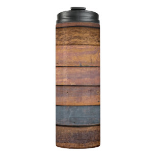 An antique wood wall texture background with metal thermal tumbler