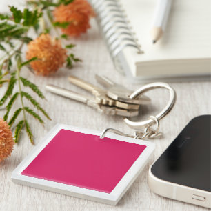 An array of red and pink flowers with lush green l key ring