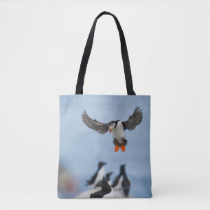 AN ATLANTIC PUFFIN COMING IN TO LAND WITH ITS WING TOTE BAG