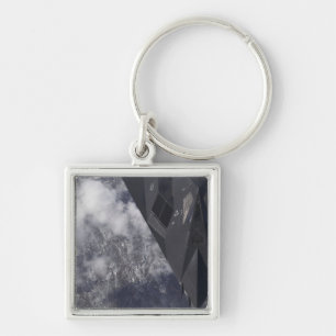 An F-117A Nighthawk flies high over the mountai Key Ring